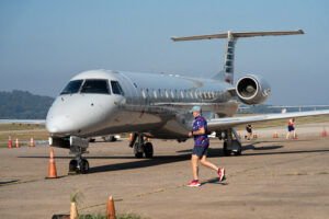 Left, Right, Left 5K runner wearing Piedmont merchandise races around an aircraft.